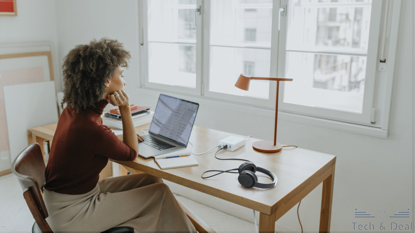 successful young afro woman sitting at her desk in her home office