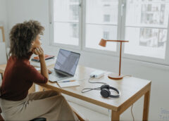 successful young afro woman sitting at her desk in her home office