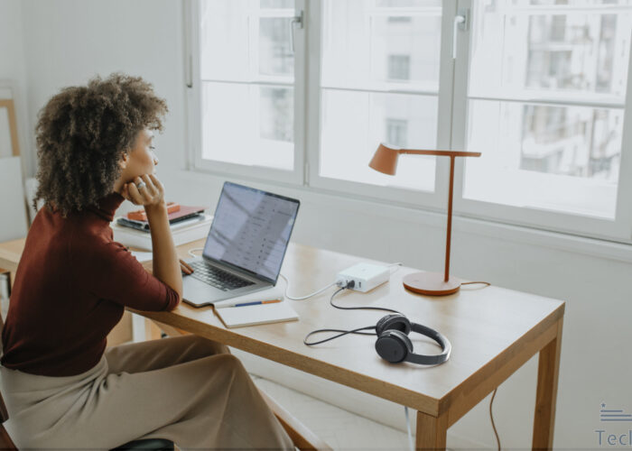 successful young afro woman sitting at her desk in her home office